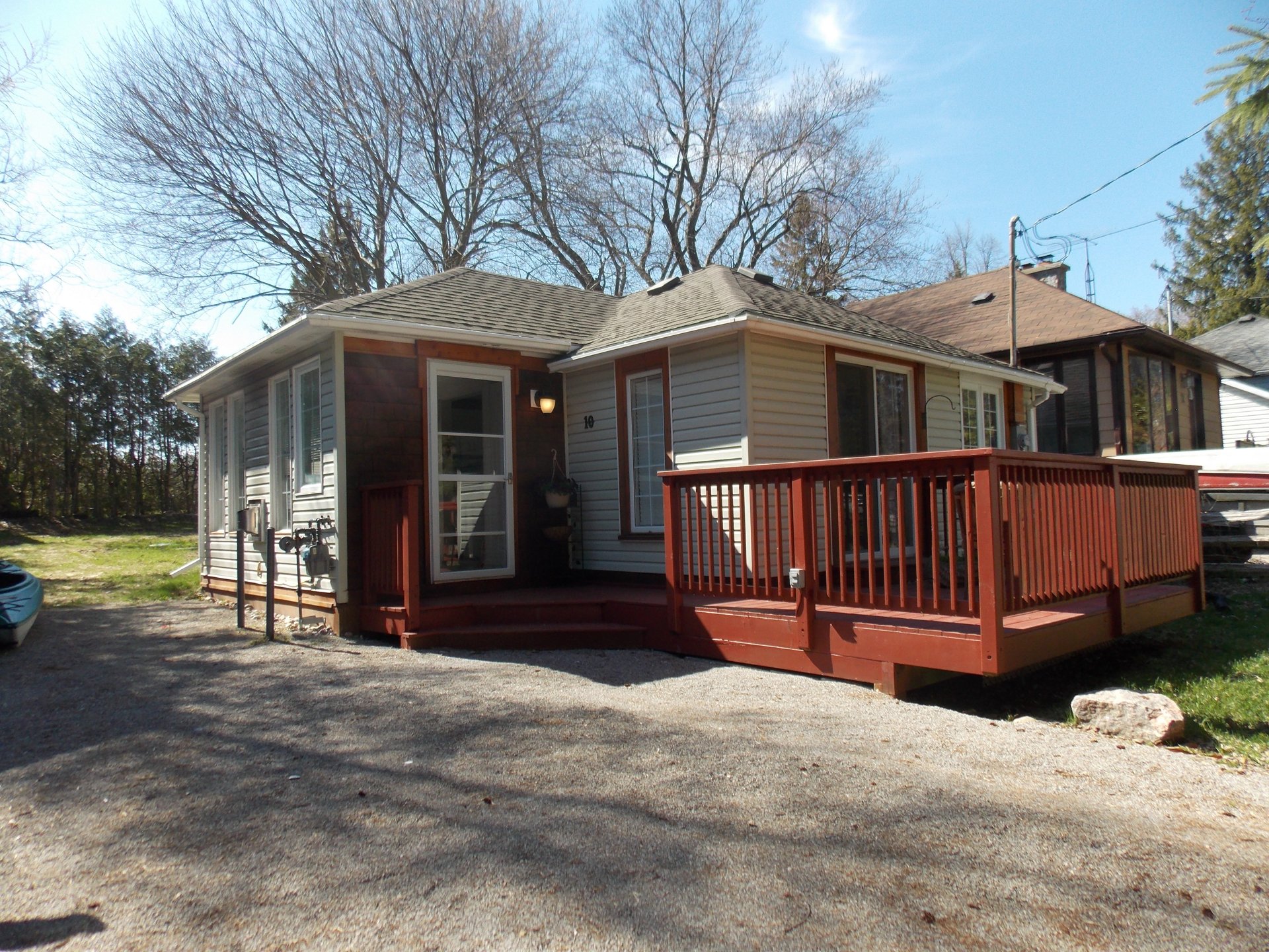 Front view of 10 Rosehill Drive with its red wooden deck