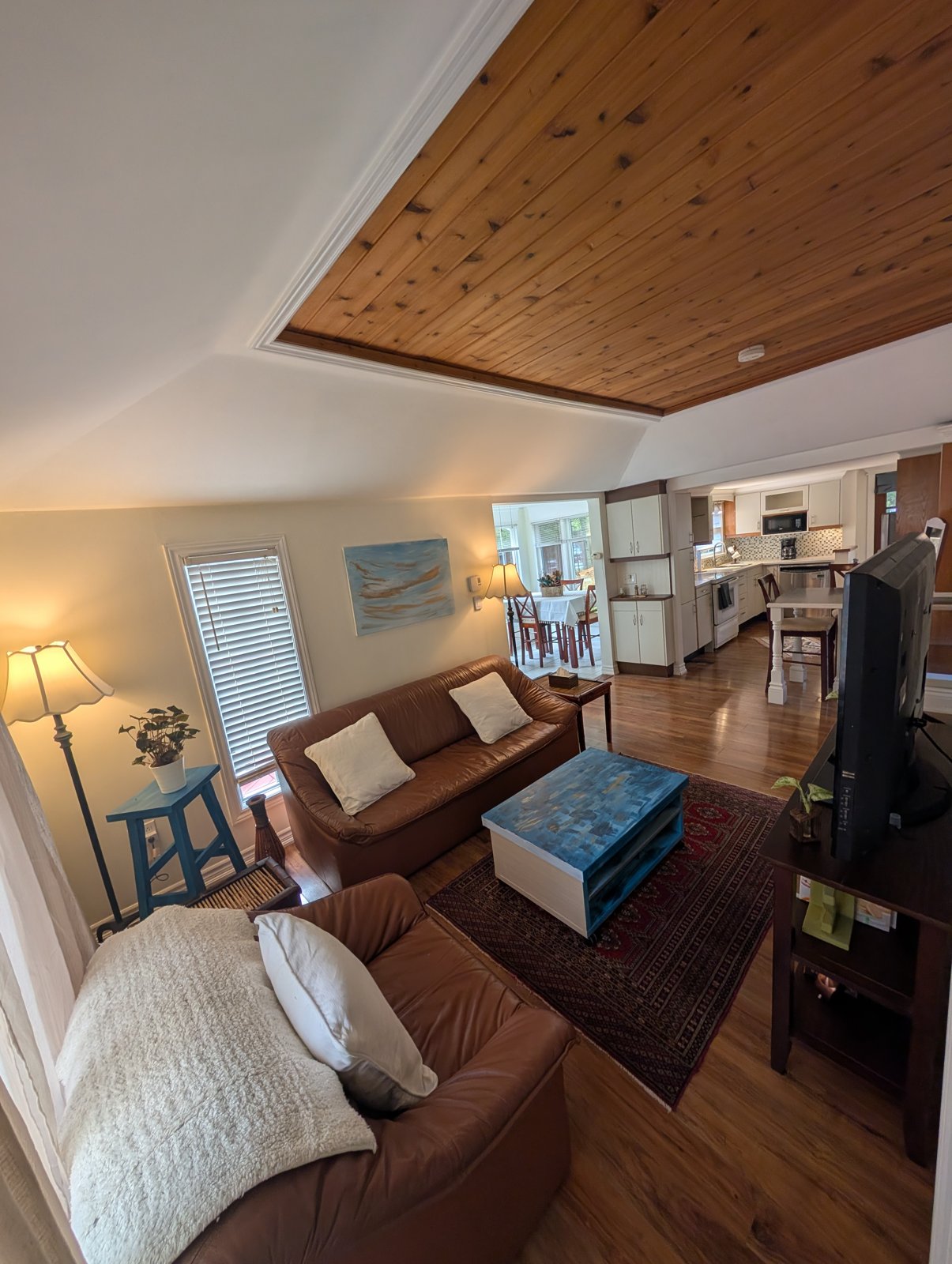 Living area with a wood ceiling and a view toward the kitchen